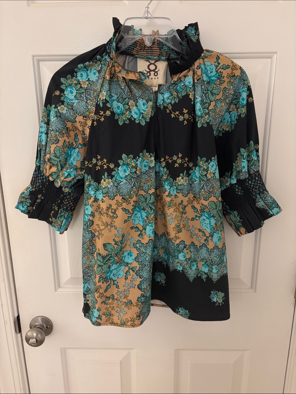 FIGUE: top with smocking at neck and sleeve. Black with blue tan print cotton
